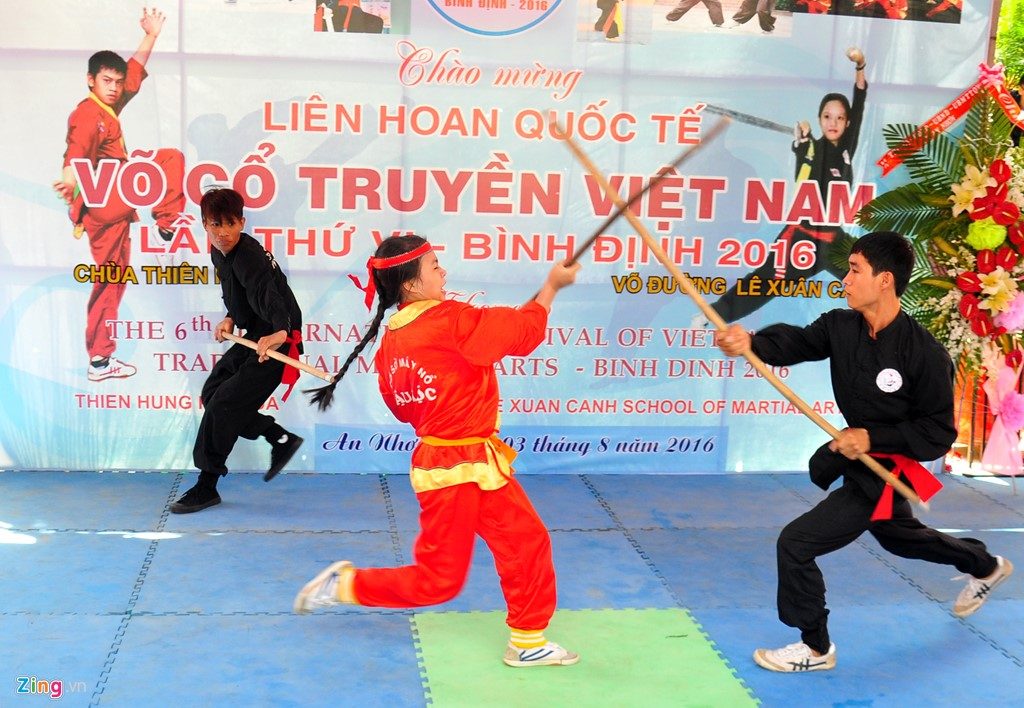 Giao lưu với các đoàn võ thuật quốc tế, nữ môn sinh võ đường Lê Xuân Cảnh trình diễn màn đấu gậy đối kháng với hai võ sinh nam. 